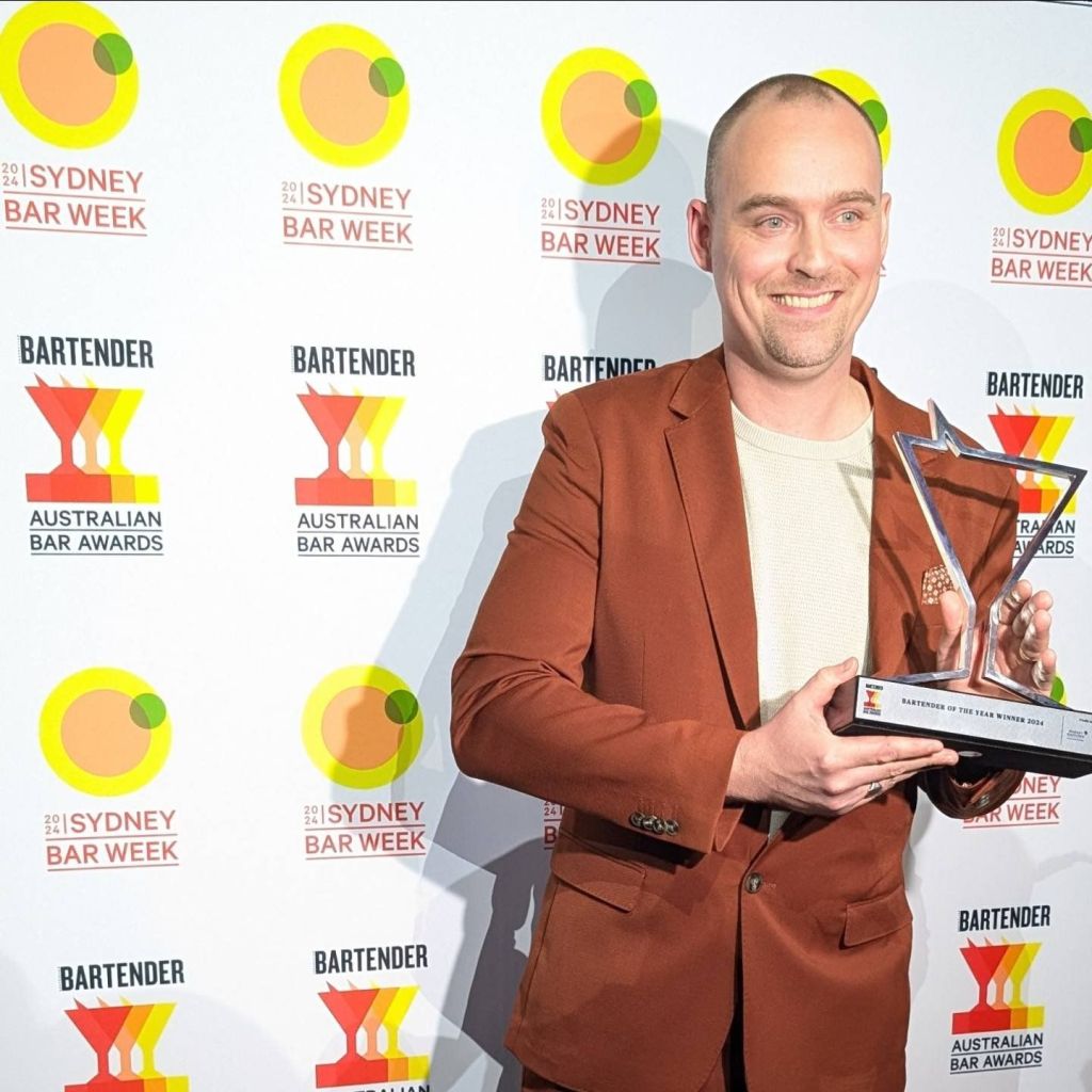 Joey holding trophy for bartender of the year